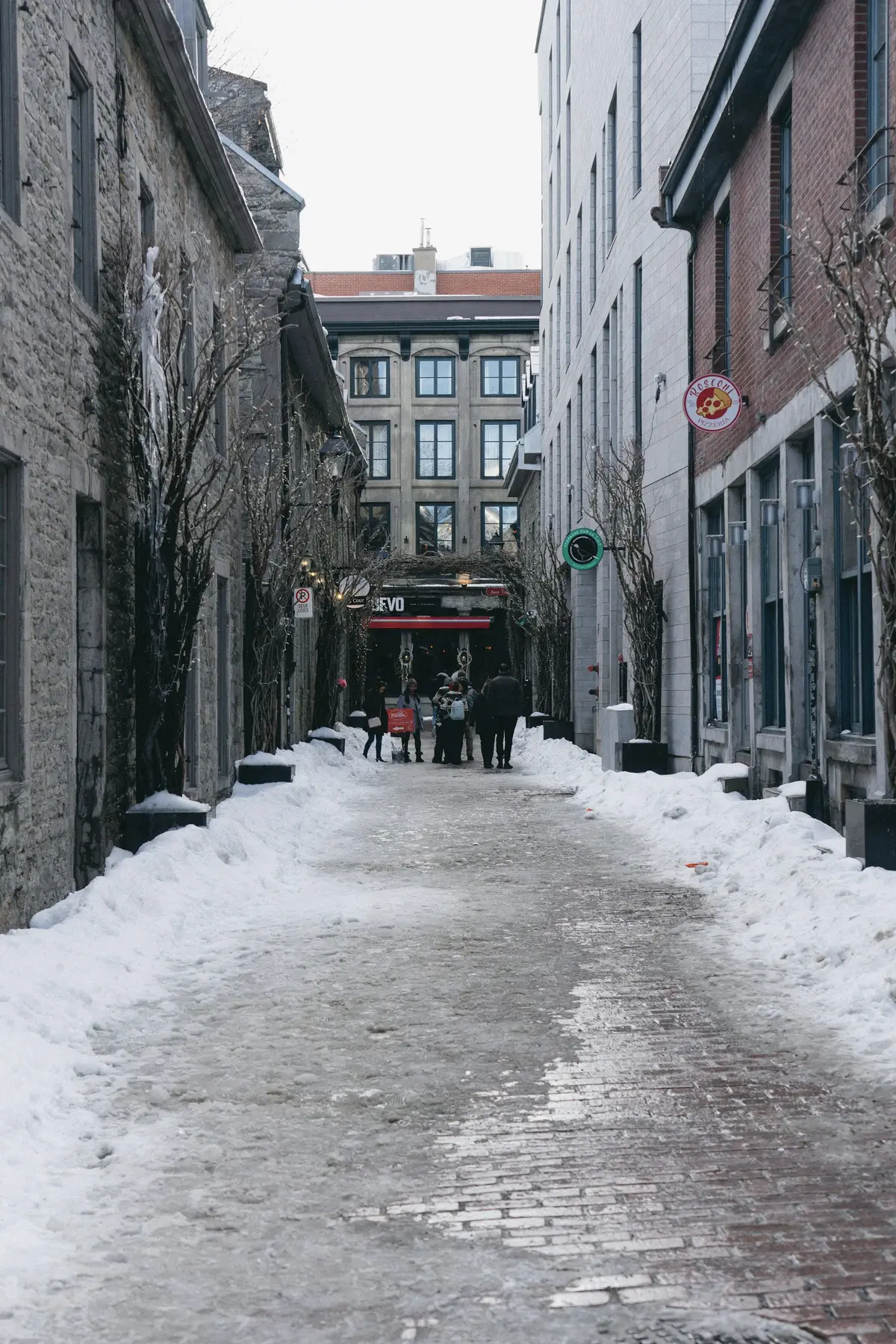 A snow-covered street between stone buildings in Vieux-Montréal